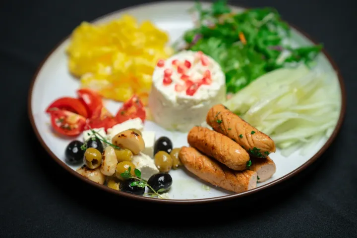 Dear Middle East Feast plate with scrambled eggs, sausage, feta, olives and tomatoes at Dear Breakfast