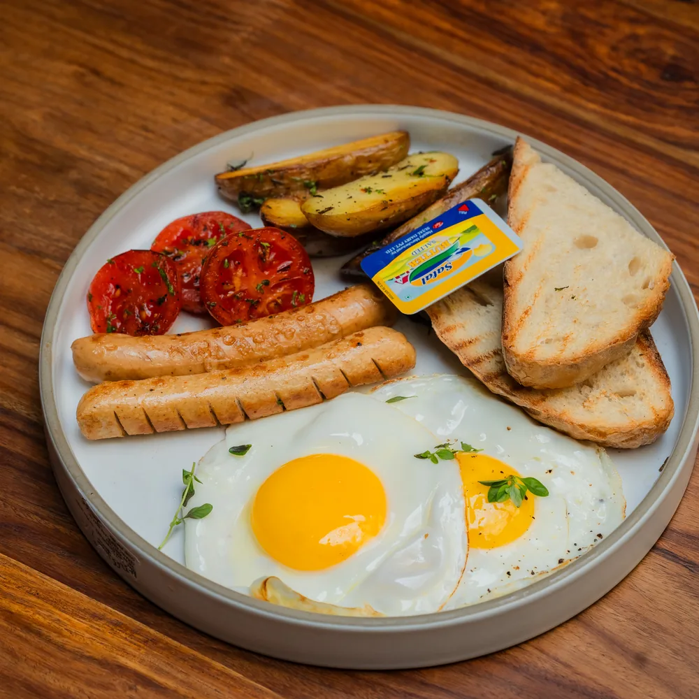 Light and Healthy Breakfast plate with eggs, toast and tomatoes at Dear Breakfast