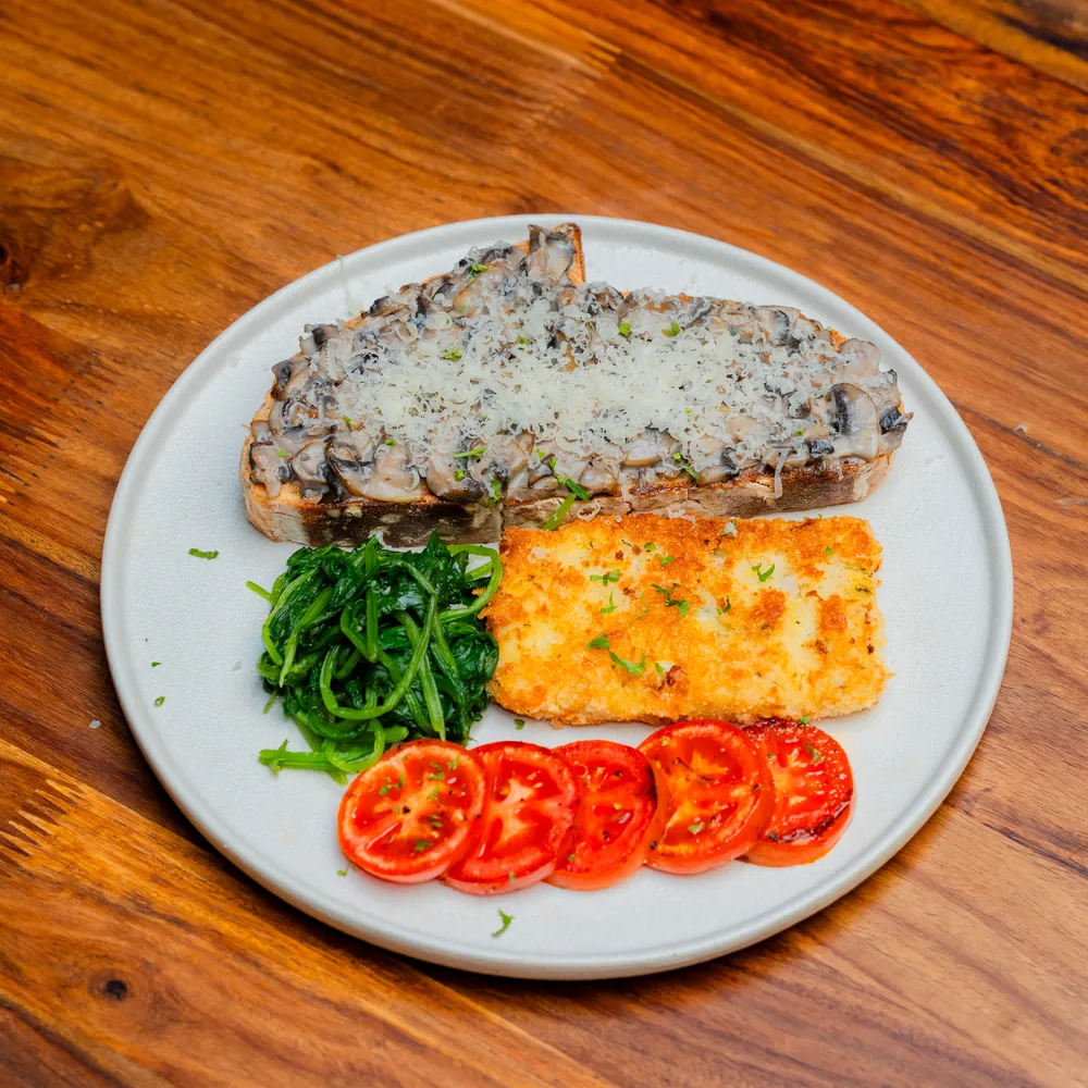 Mushroom Delight breakfast plate with toast, spinach, tomatoes and egg at Dear Breakfast